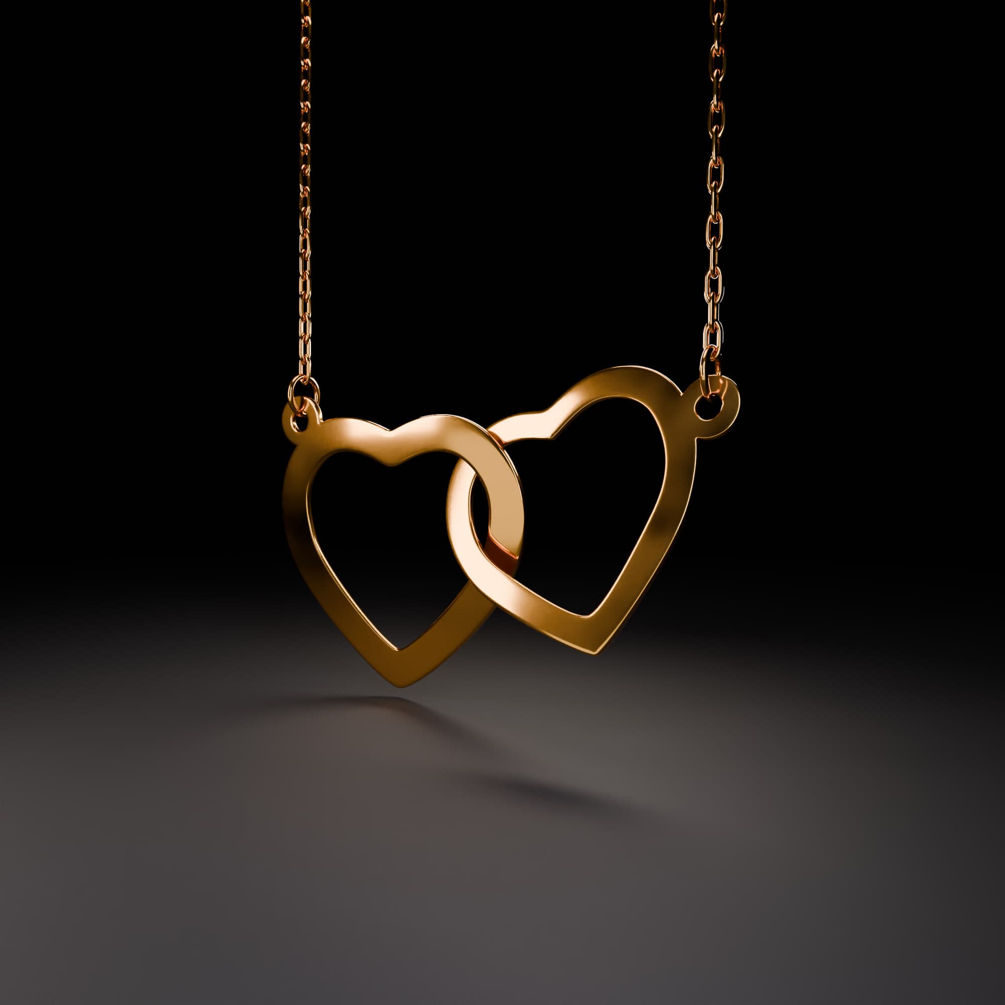 The gold hearts necklace: two interlocking heart pendants on a chain of individually placed links.